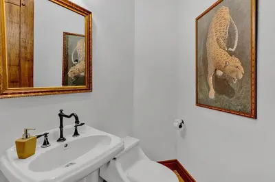 a bathroom with a sink and a toilet and a mirror at Ocean Front Palacio Tropical in Puntarenas