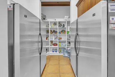 a kitchen with two stainless steel refrigerators at Ocean Front Palacio Tropical in Puntarenas