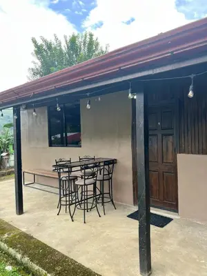 a patio with a table and chairs on it at Apartamento Chic en la Montaña AC in Turrialba