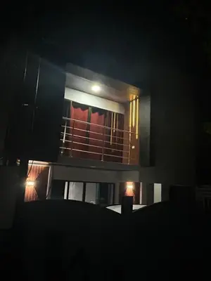 a view of a building with a balcony at night at Villa JADE, La Fortuna Downtown Apartment in Fortuna