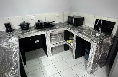 a kitchen with a marble counter top and a sink at Villa JADE, La Fortuna Downtown Apartment in Fortuna