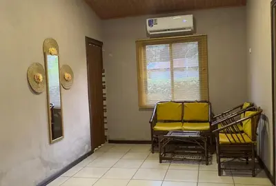 a living room with two chairs and a heater at Casa Mangos Macondo Lepanto in Lepanto
