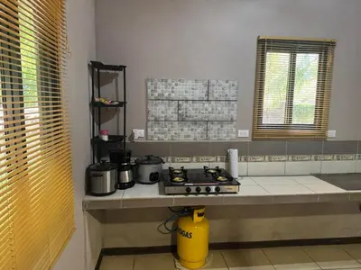 a kitchen with a counter top with a stove at Casa Mangos Macondo Lepanto in Lepanto