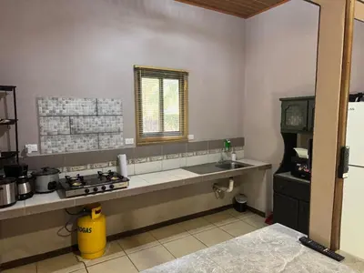 a kitchen with a counter and a sink in it at Casa Mangos Macondo Lepanto in Lepanto