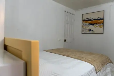 a bed in a room with a picture on the wall at Nido del Parque, Zarcero in Zarcero