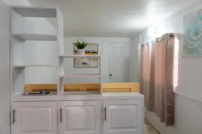 a room with white cabinets and a shelf in it at Nido del Parque, Zarcero in Zarcero