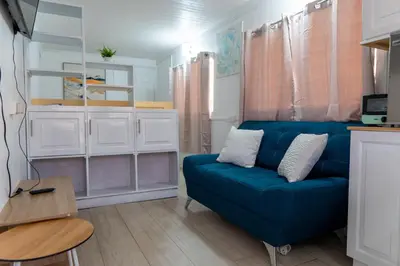 a living room with a blue couch and a table at Nido del Parque, Zarcero in Zarcero