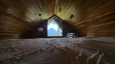 a room with a window in a wooden wall at Arenal 360 Lodge in Fortuna