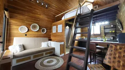 a tiny house with a bunk bed and a kitchen at Arenal 360 Lodge in Fortuna