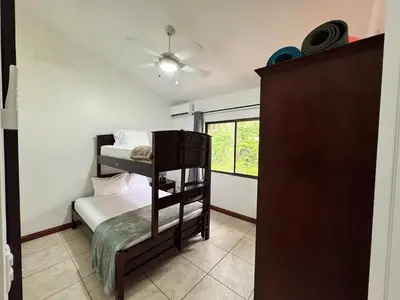 a bedroom with two bunk beds and a ceiling fan at Serena Suites H3 in Coco