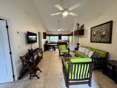 a living room with green chairs and a couch at Serena Suites H3 in Coco