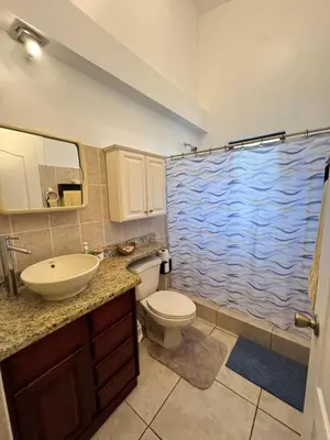 a bathroom with a toilet and a sink and a shower at Serena Suites H3 in Coco