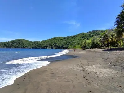 a beach with a person walking on the beach at Serena Suites H3 in Coco