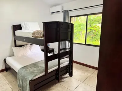 a room with two bunk beds and a window at Serena Suites H3 in Coco