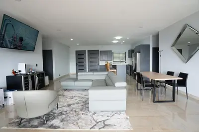 a living room with a couch and a table at La Parada House in Heredia