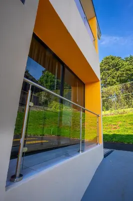 a balcony of a house with a large window at La Parada House in Heredia