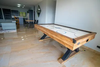 a ping pong table in the middle of a room at La Parada House in Heredia