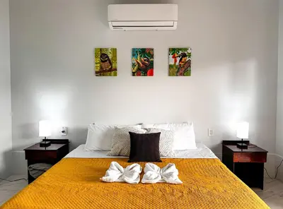 a bedroom with a bed with two towels on it at MaBri Arenal Home in Agua Azul