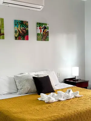 a bedroom with a bed with towels on it at MaBri Arenal Home in Agua Azul