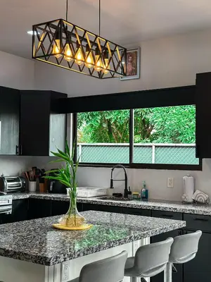 a kitchen with a counter with a vase on it at MaBri Arenal Home in Agua Azul