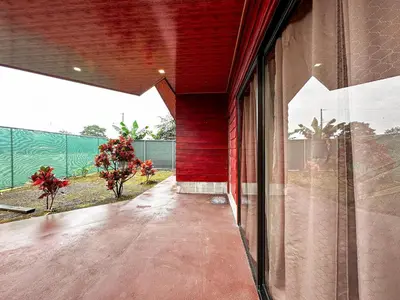 an external view of a house with a red wall at MaBri Arenal Home in Agua Azul