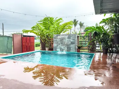 a swimming pool in the middle of a house at MaBri Arenal Home in Agua Azul