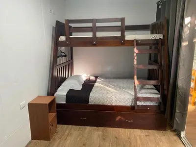 a bedroom with two bunk beds and a staircase at Casa Guanabana in Nicoya