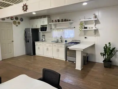 a kitchen with white cabinets and a refrigerator at Casa Guanabana in Nicoya