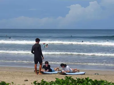 a group of people laying on surfboards on the beach at Casa Guanabana in Nicoya
