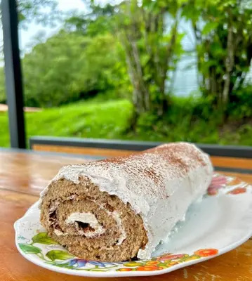 a piece of cake on a plate on a table at Casa Grano de Oro Cozy Home in Monteverde in Turín