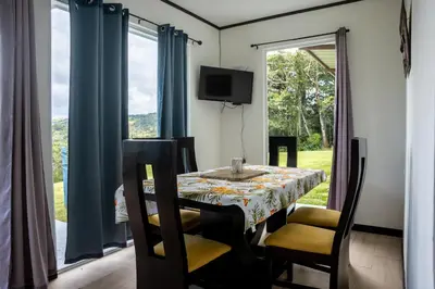 a dining room with a table and a window at Casa Grano de Oro Cozy Home in Monteverde in Turín