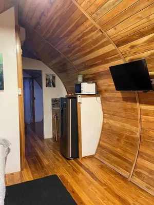 a room with a refrigerator and a flat screen tv at Villas alice in Huacas