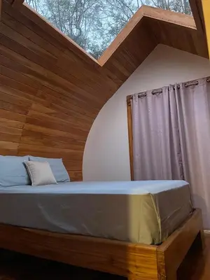 a bedroom with a large bed with a skylight at Villas alice in Huacas