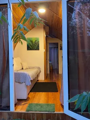 a small room with a bed and a window at Villas alice in Huacas