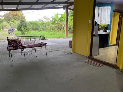 a bench sitting in the middle of a patio at Casa Vacacional fachento house in Parrita