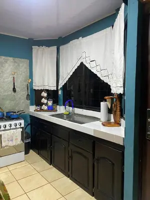 a kitchen with a sink and a counter top at Casa Vacacional fachento house in Parrita