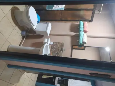 an overhead view of a bathroom with a toilet and towels at Casa Vacacional fachento house in Parrita