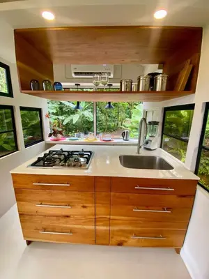 a kitchen with a sink and a stove at Jungle Bus, 5 min drive to PlayaLinda, 15 to Dominical, Wifi Starlink in Quepos