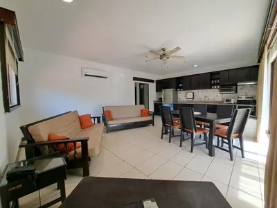 a living room with a couch and a table at Papagayo Hotel y Villas in Playa Panama
