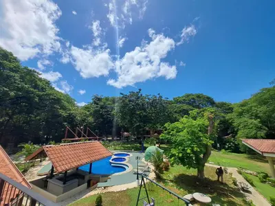 a view of a swimming pool in a park at Papagayo Hotel y Villas in Playa Panama