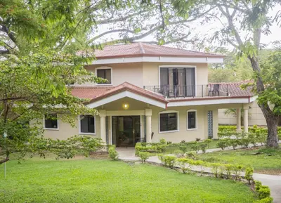a house with a large yard in front of it at Papagayo Hotel y Villas in Playa Panama