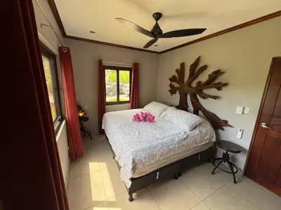 a bedroom with a bed with pink flowers on it at Condominio Punta Plata in Playa Flamingo
