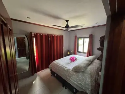 a bedroom with a bed with pink flowers on it at Condominio Punta Plata in Playa Flamingo