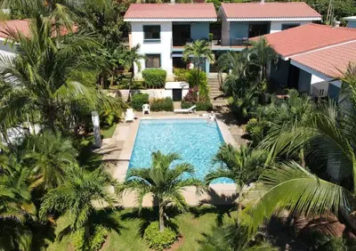 an aerial view of a swimming pool in front of a house at Minimalist Condo with a Beautiful New Design, Bound Patio, and Shared Community Pool in Coco