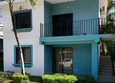 a blue and white building with a balcony at Minimalist Condo with a Beautiful New Design, Bound Patio, and Shared Community Pool in Coco