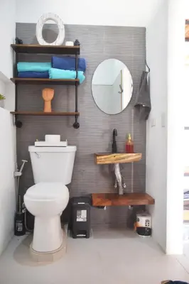 a bathroom with a toilet and a mirror at Nanay's House in Venado