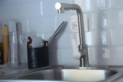 a kitchen sink with a faucet in a kitchen at Nanay's House in Venado