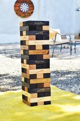 a stack of wooden blocks sitting on the grass at Nanay's House in Venado