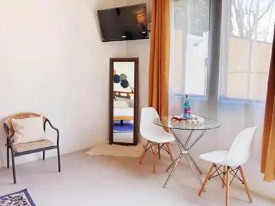 a room with a table and chairs and a mirror at Nanay's House in Venado