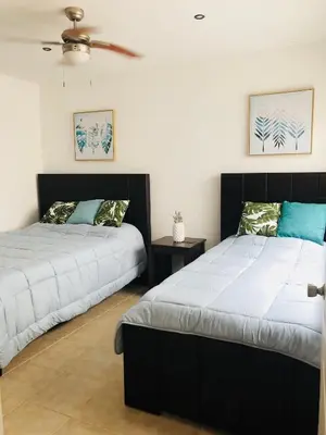 two beds sitting next to each other in a bedroom at La buena vida ocean Tamarindo in Libertad